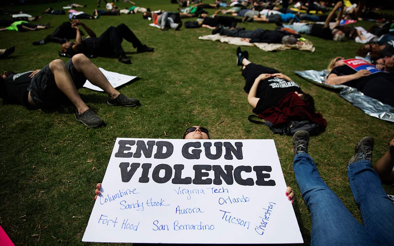 Nicole Alvarez holds a sign during a "die-in" protest against the National Rifle Association's annual convention, April 2017. 