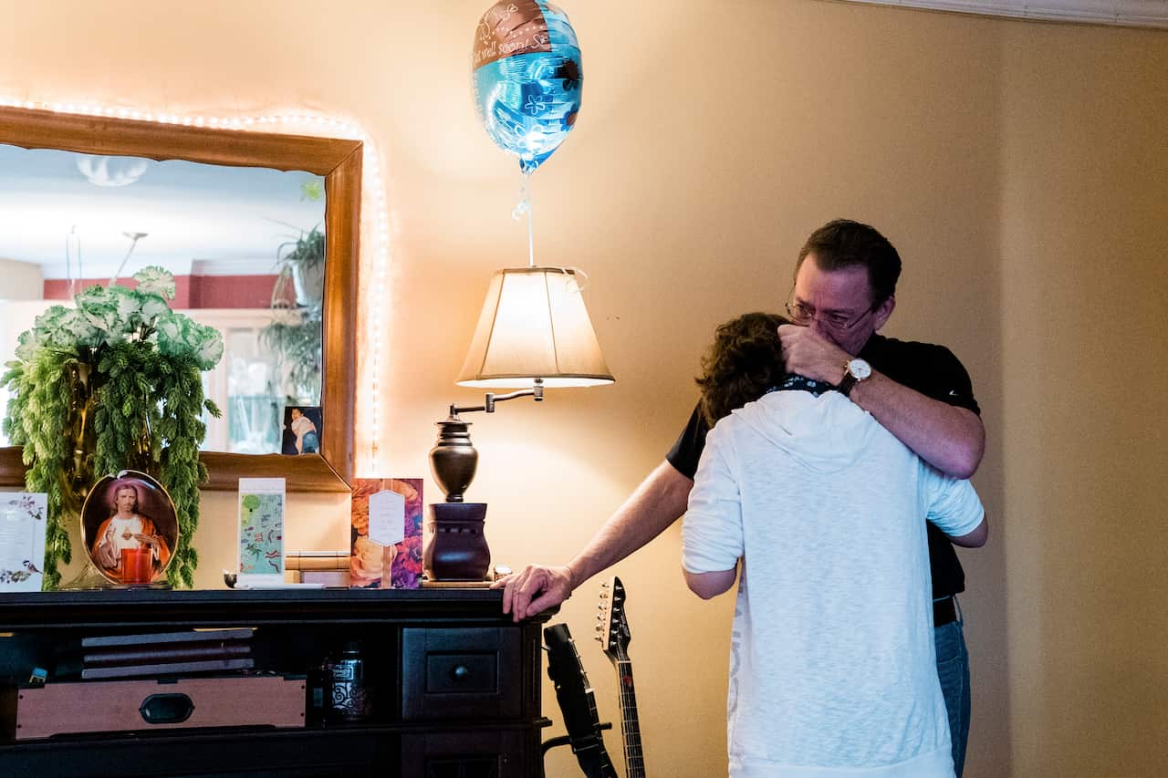 After his father, John McMorrow, choked up recounting his son's illness, Jack McMorrow embraced him at their in Queens, May 11, 2020. (Gabriela Bhaskar/The New York Times)
