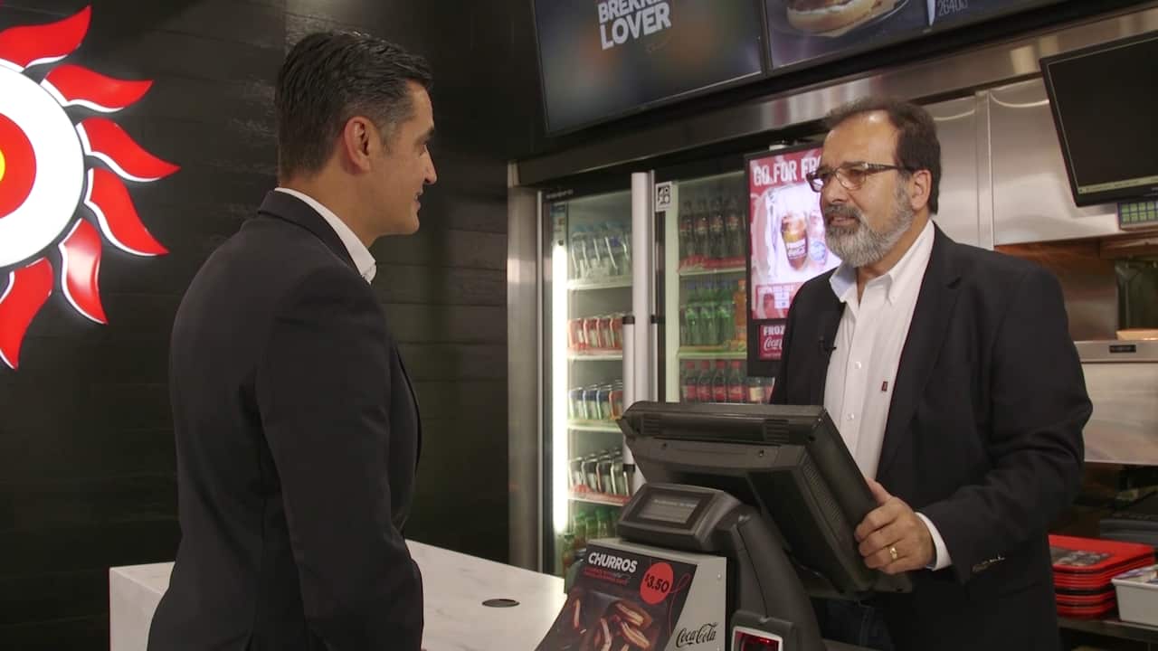 Antonio serves up his Portuguese chicken to Ricardo Goncalves.