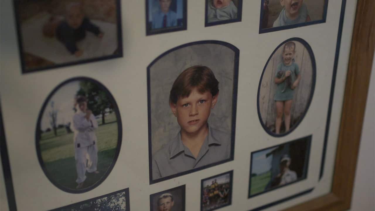 Photos of Courtney and his family adorn the walls of their home.