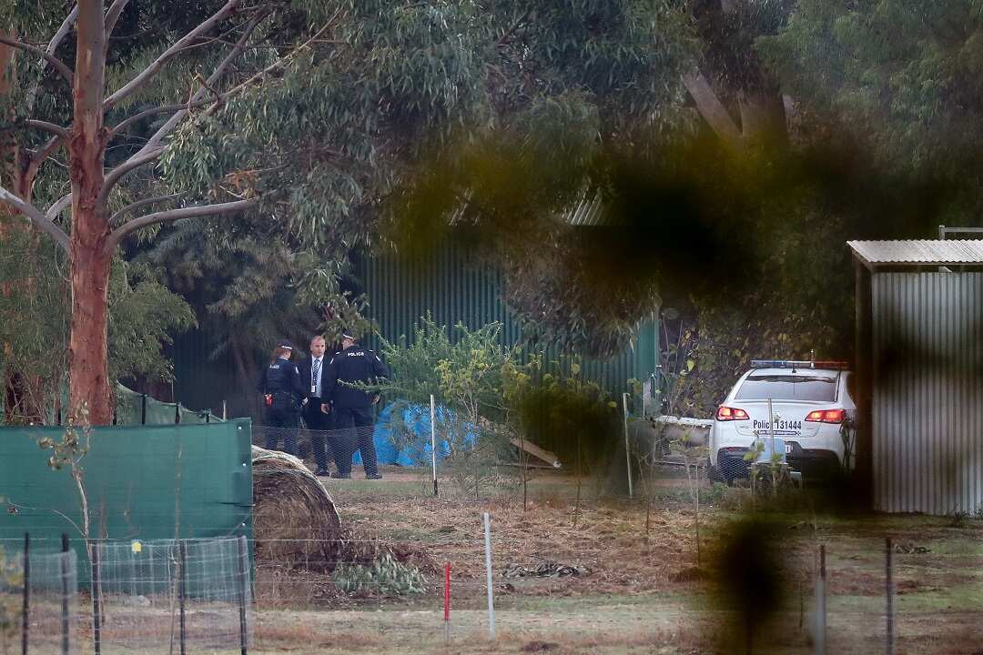 Police continue their crime scene investigation at the rural property.