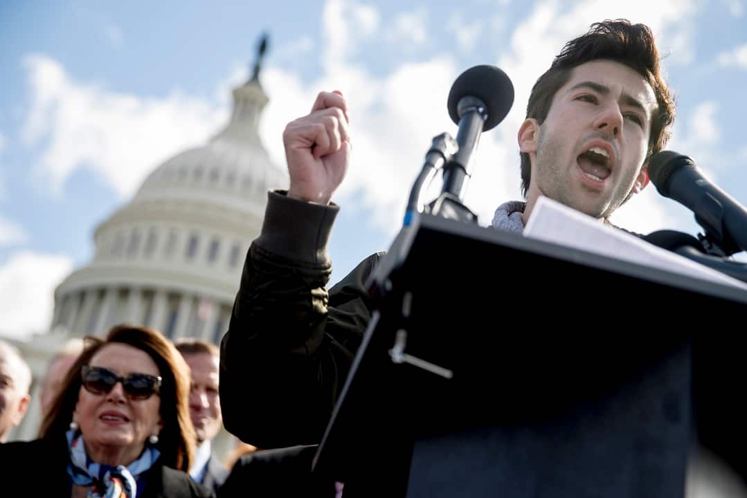 Student activist Matt Post of Md., right, accompanied by House Minority Leader Nancy Pelosi left, speaks during a student led gun control rally outside the Capitol Building in Washington, Wednesday, March 14, 2018.