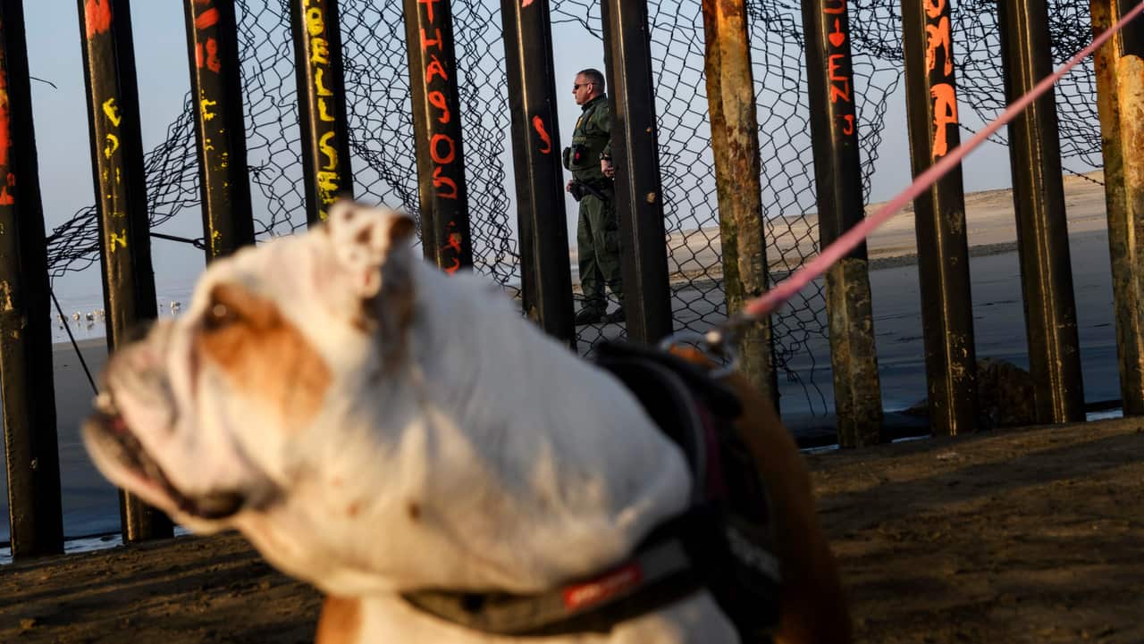 A US Border Patrol agent works on the beach preventing migrants from entering San Diego, as seen from Tijuana, Mexico.