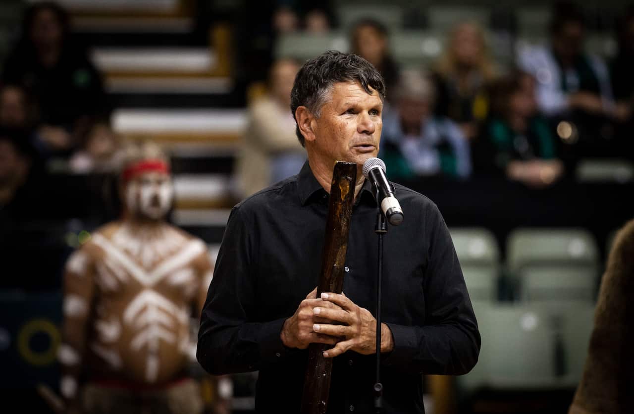 Dr Richard Walley OAM and the Sunrise Dancers from the Sunshine Coast perform a welcome to country for the Indigenous Round 10 Super Netball match.