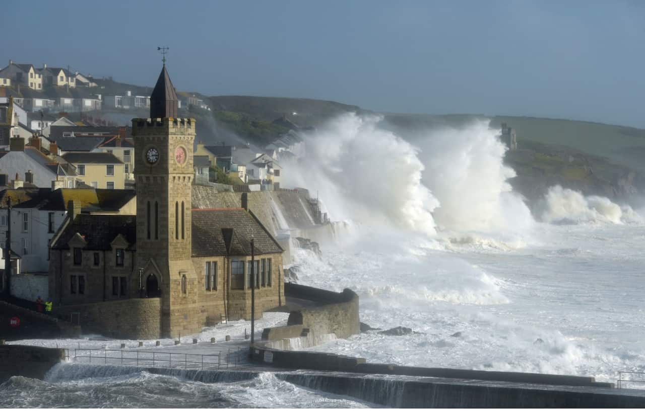 Waves break around the church in the harbour at Porthleven, Cornwall, as Hurricane Ophelia hits the UK and Ireland with gusts of up to 80mph.