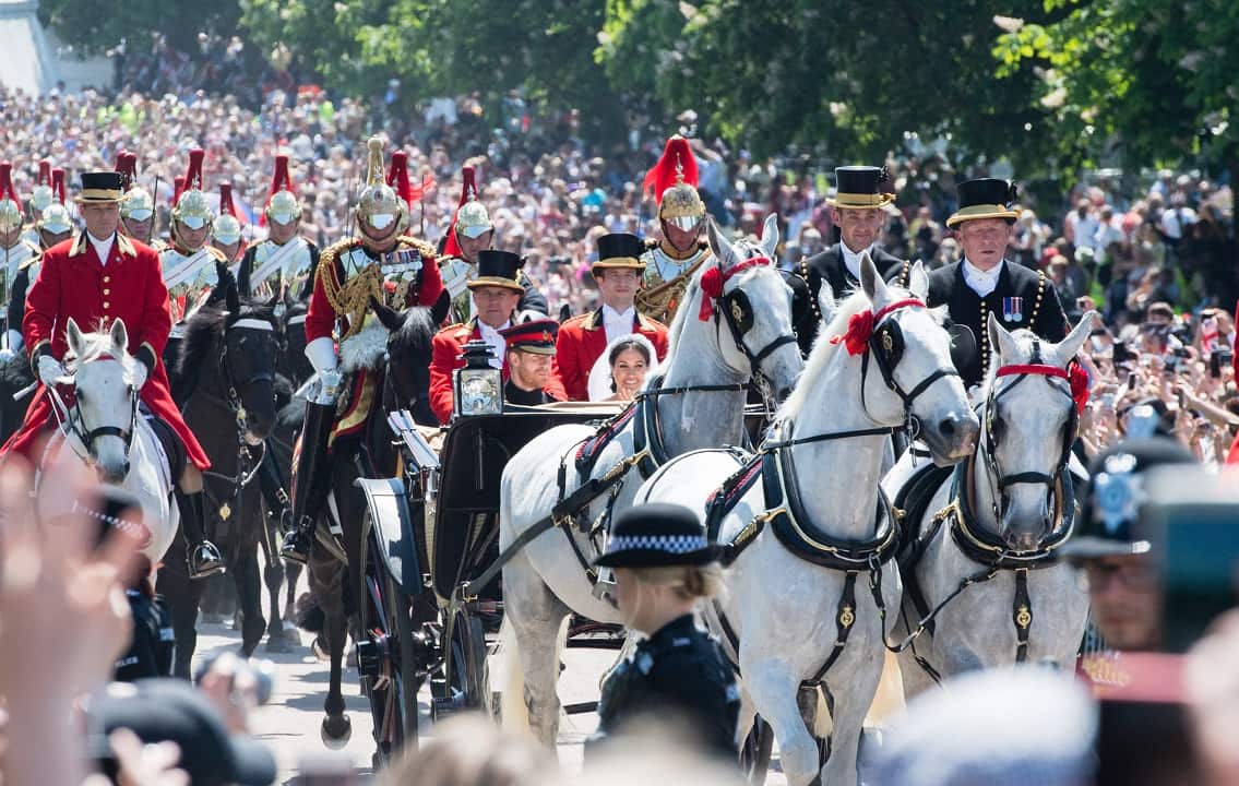 Prince Harry, Duke of Sussex and Meghan, Duchess of Sussex ride in the Ascot Landau carriage during the procession after getting married.