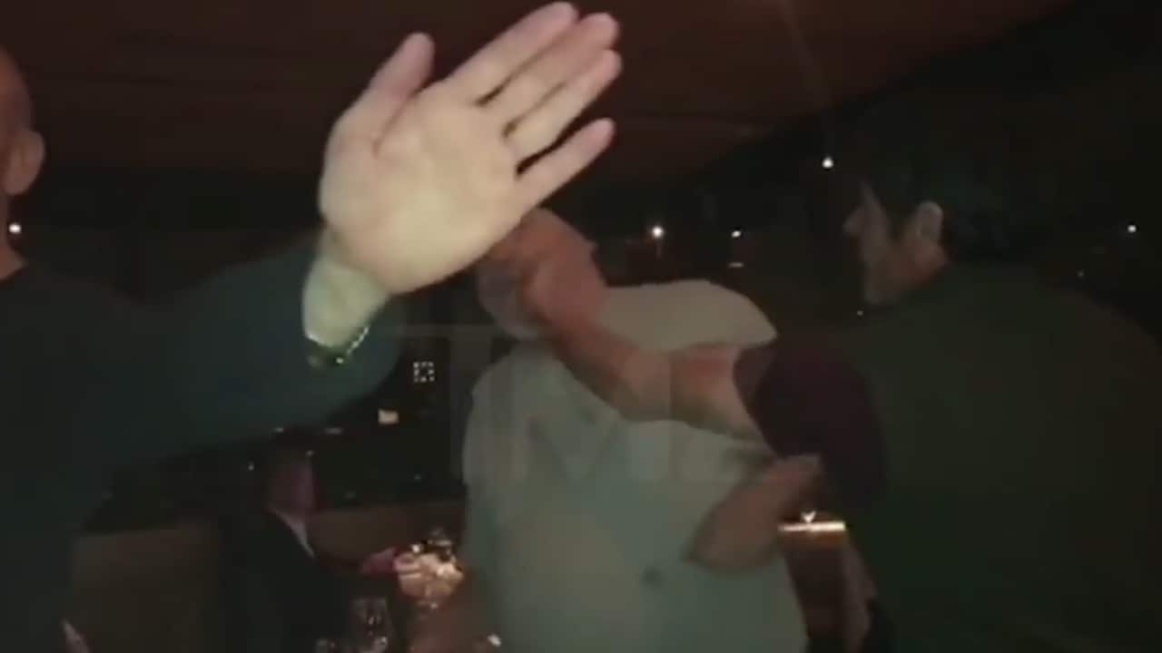 The moment the patron named only as Steve makes contact with Weinstein's cheek.