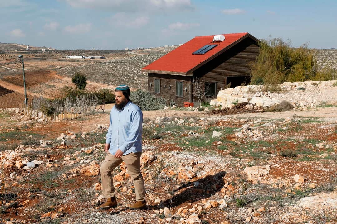 Nati Rom, who is against the Palestnian-led boycott movement, walks next to an Airbnb apartment located in the occupied West Bank. 
