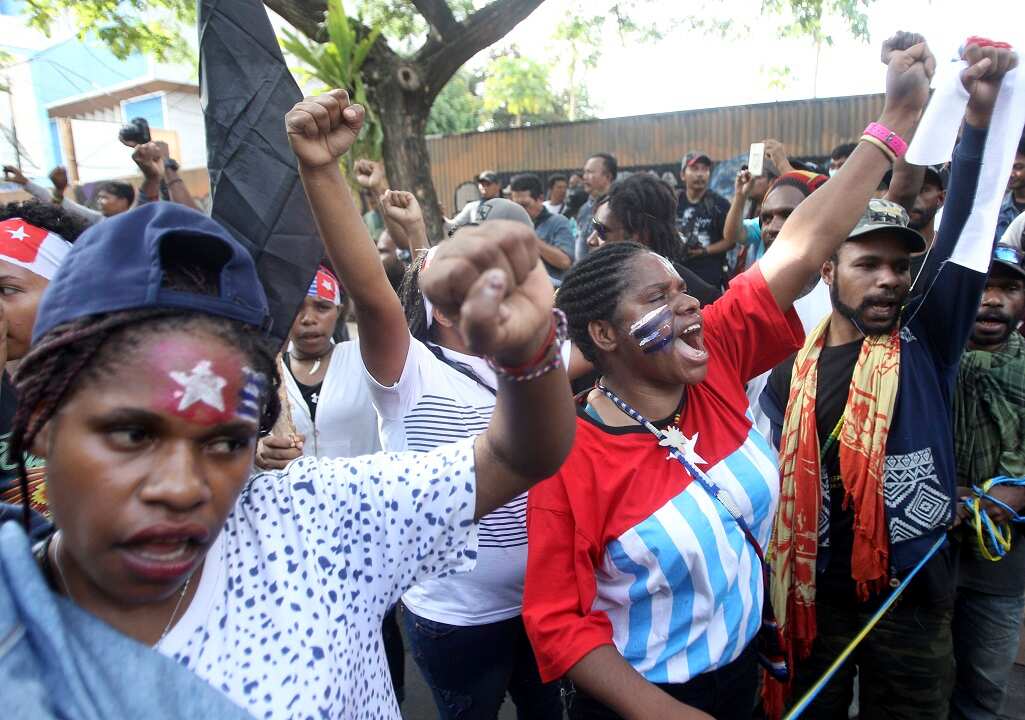 Papuan activists with their face painted with banned separatist flag the 'Morning Star'.