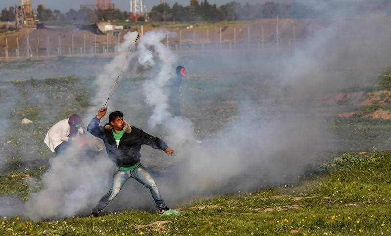 A Palestinian seen using a slingshot to throw a gas canister back to Israeli soldiers during a clash last year.