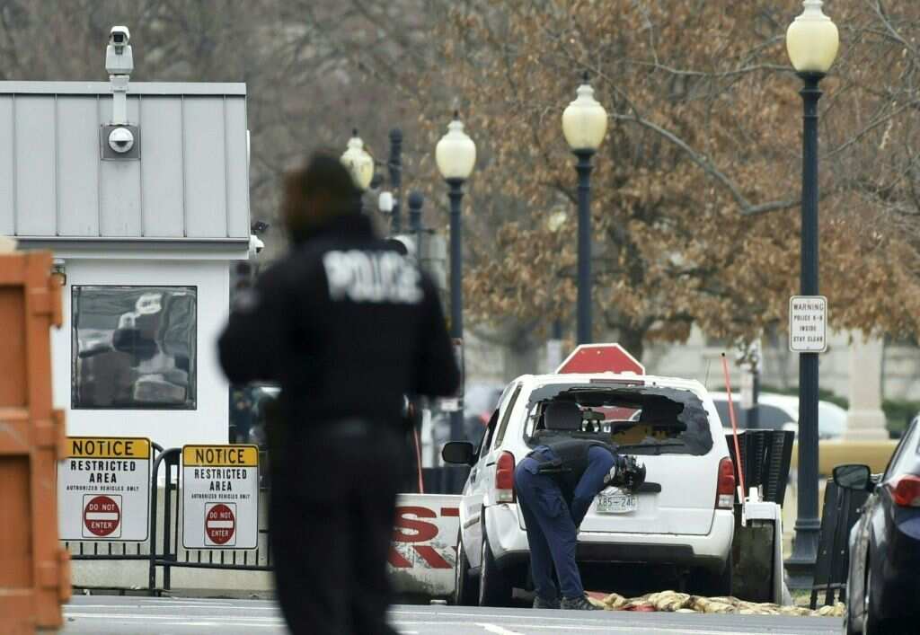 A passenger car sits at a security barrier it appears to have struck near the White House in Washington, DC on 23 February, 2018.