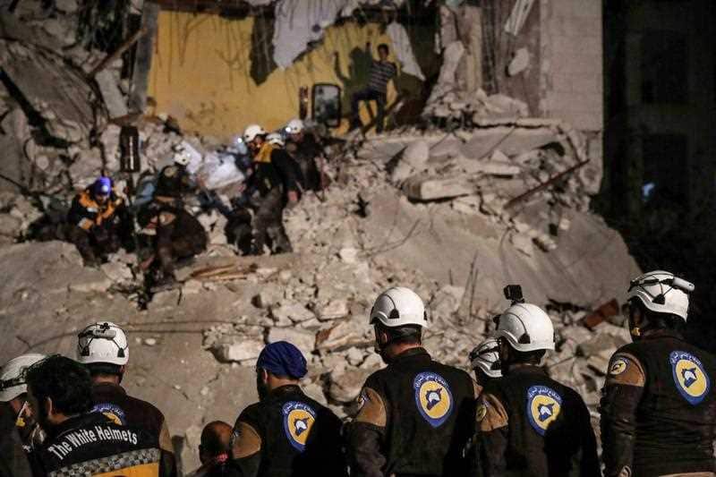 Volunteers from the White Helmets search for survivors after an explosion in the city of Idlib, Syria.