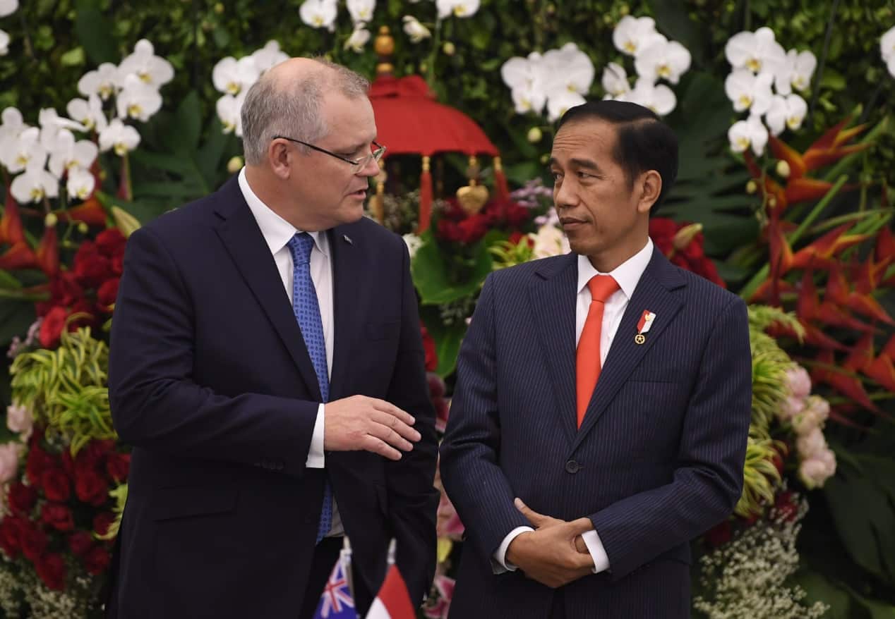 Australian Prime Minister Scott Morrison and File: Indonesian President Joko Widodo speak as they witness a signing ceremony at Bogor Presidential Palace
