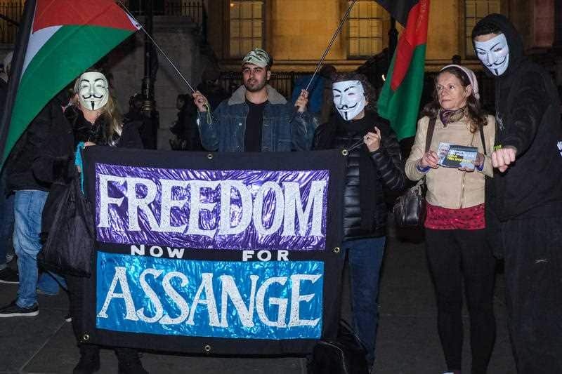 Protesters hold a a sign in support of Wikileaks founder Julian Assange in Trafalgar Square London.