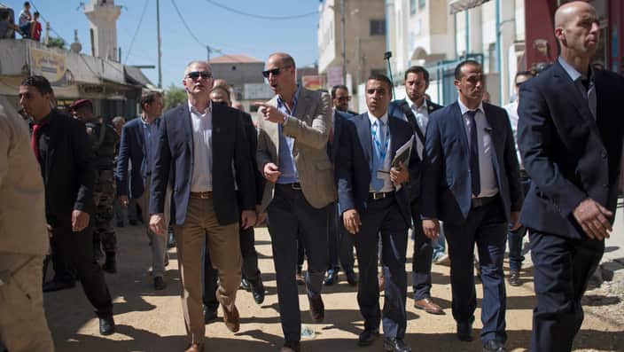 Britain's Prince William, center, tours the Al-Jalzoun refugee camp near the West Bank city of Ramallah.
