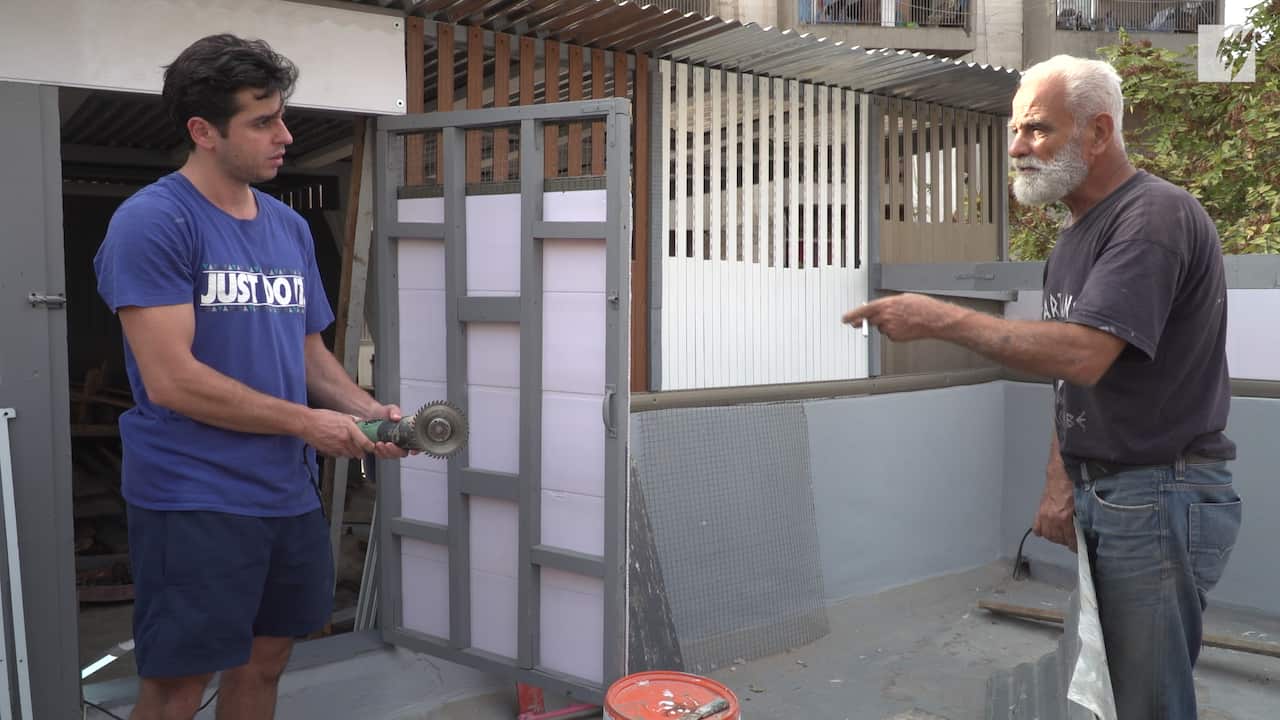 William helps Ghassan fix his rooftop.