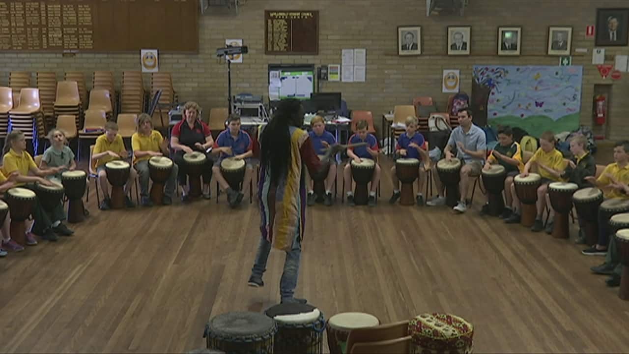 Drum teacher Yacou Mbaye with students at Wollondilly Public School in Goulburn.