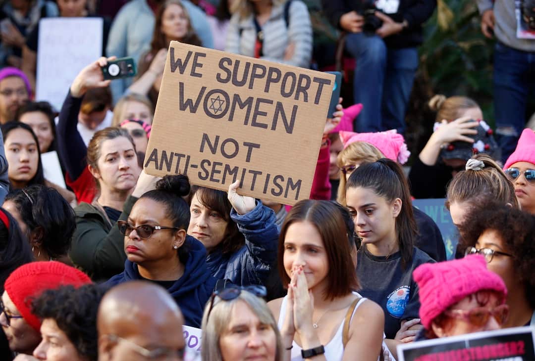 A demonstrators holds a sign against "Anti-Semitism" as she joins the Women's March in Los Angeles on Saturday, Jan. 19, 2019. (AP Photo/Damian Dovarganes)
