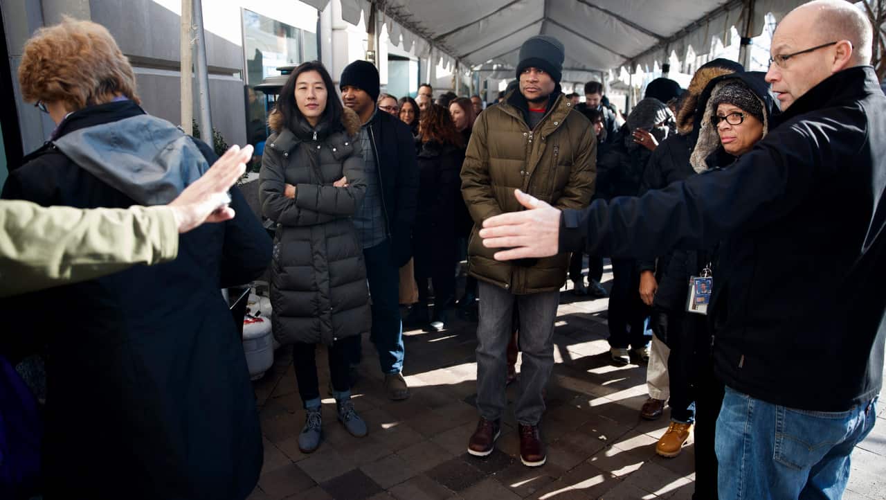 Federal furloughed employees line up to receive free lunch at the World Central Kitchen in Washington, DC.