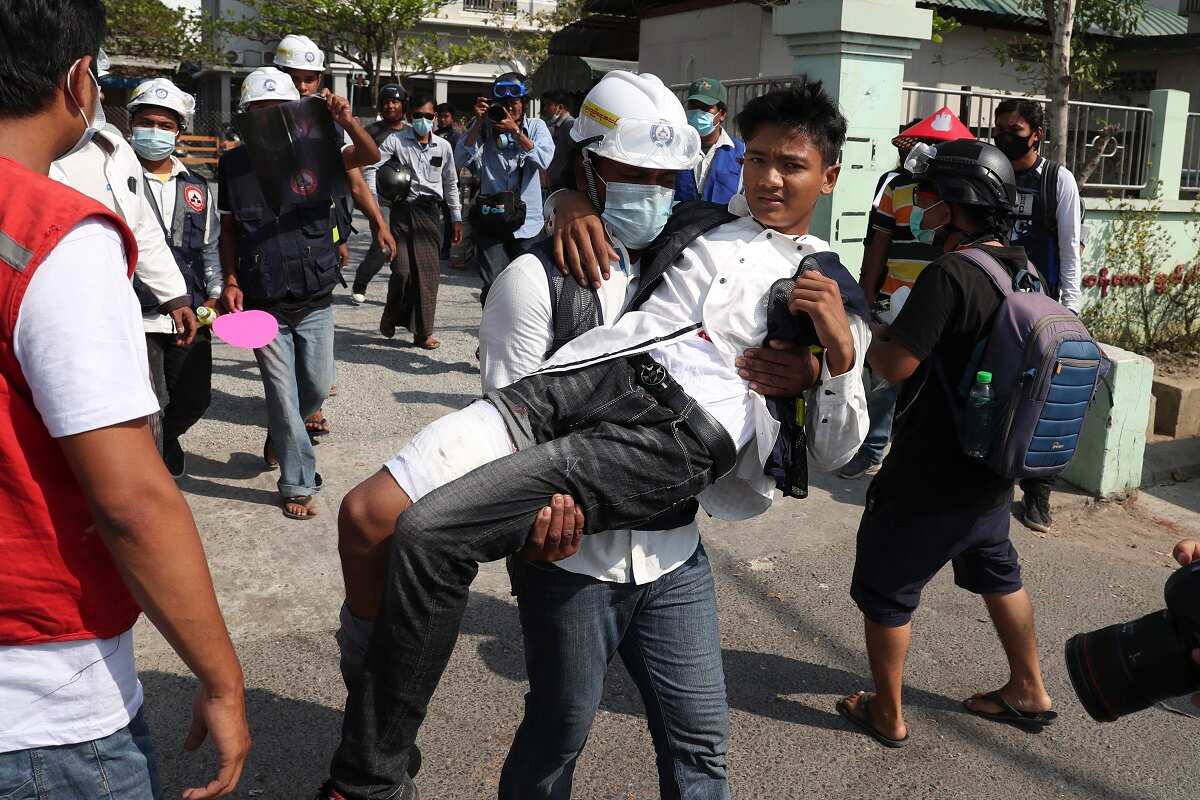 A wounded protester is carried during a protest against the military coup in Mandalay, Myanmar, Sunday, Feb. 28, 2021. 