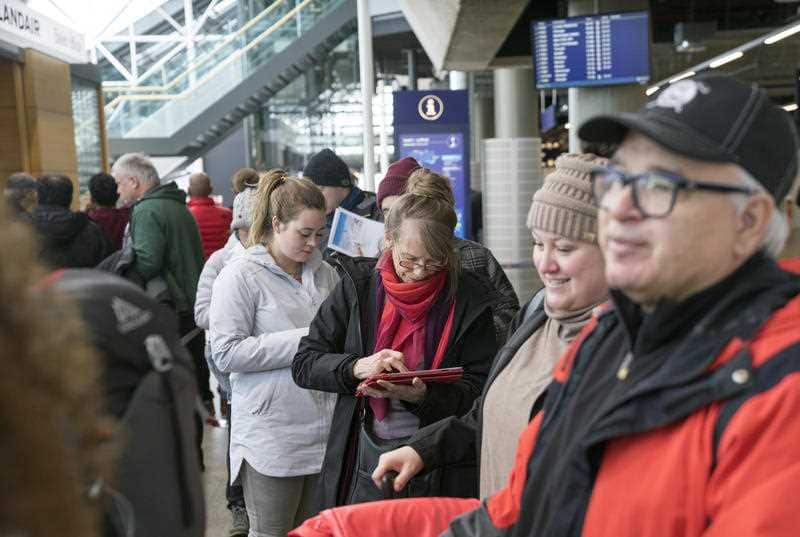 Stranded passengers set to travel with Icelandic airline Wow, wait in line at Iceland's international airport in Keflavik.