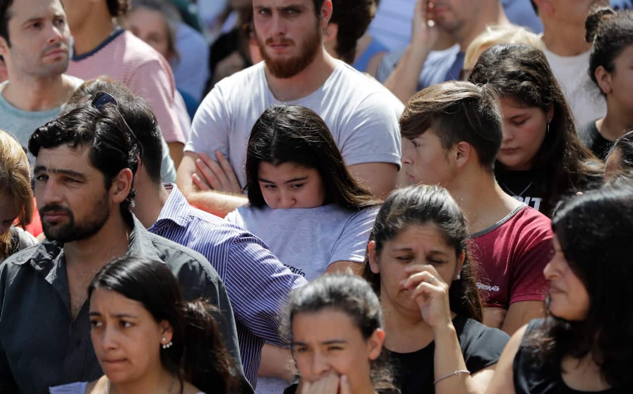 Neighbors of Argentine soccer player Emiliano Sala, wait for his remains to depart for Santa Fe after his wake in Progreso, Argentina, Saturday, Feb. 16, 2019. 