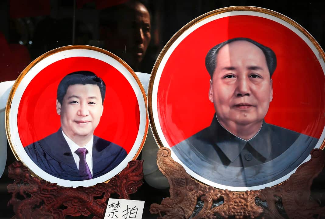 Souvenir plates bearing images of Xi Jinping, left, and late Mao Zedong are displayed at a shop near Tiananmen Square in Beijing.