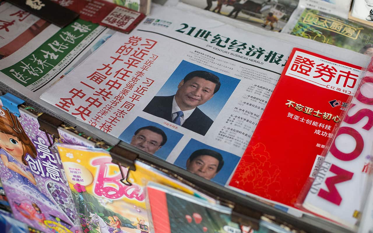 Newspapers with photos showing Chinese President Xi Jinping and the new members of the Standing Committee of the Politburo on sale in Beijing.