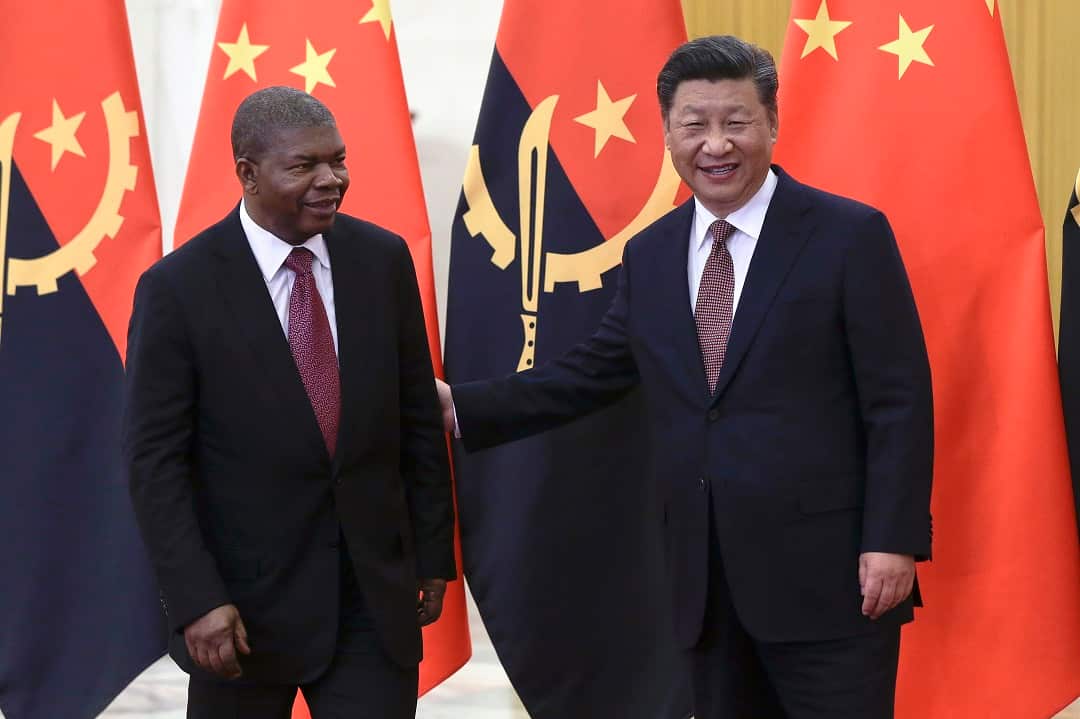 Angola's President Joao Lourenco, left, and Chinese President Xi Jinping prepare for their bilateral meeting at the Great Hall of the People in Beijing, Sunday, Sept. 2, 2018. (AP Photo/Andy Wong, Pool)