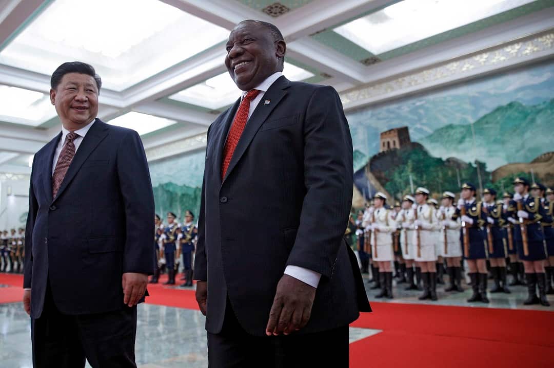 South African President Cyril Ramaphosa, walks with Chinese President Xi Jinping after reviewing an honor guard.