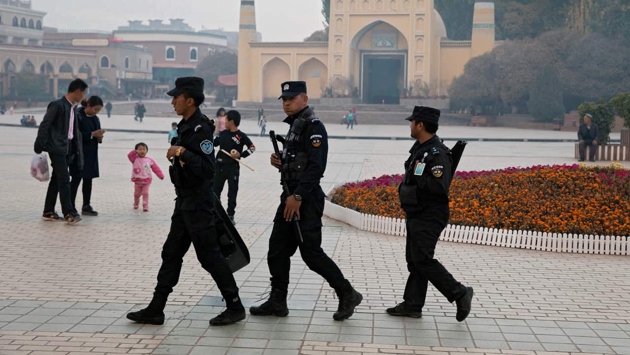 Uighur security personnel patrol near the Id Kah Mosque in Kashgar in western China's Xinjiang region. 