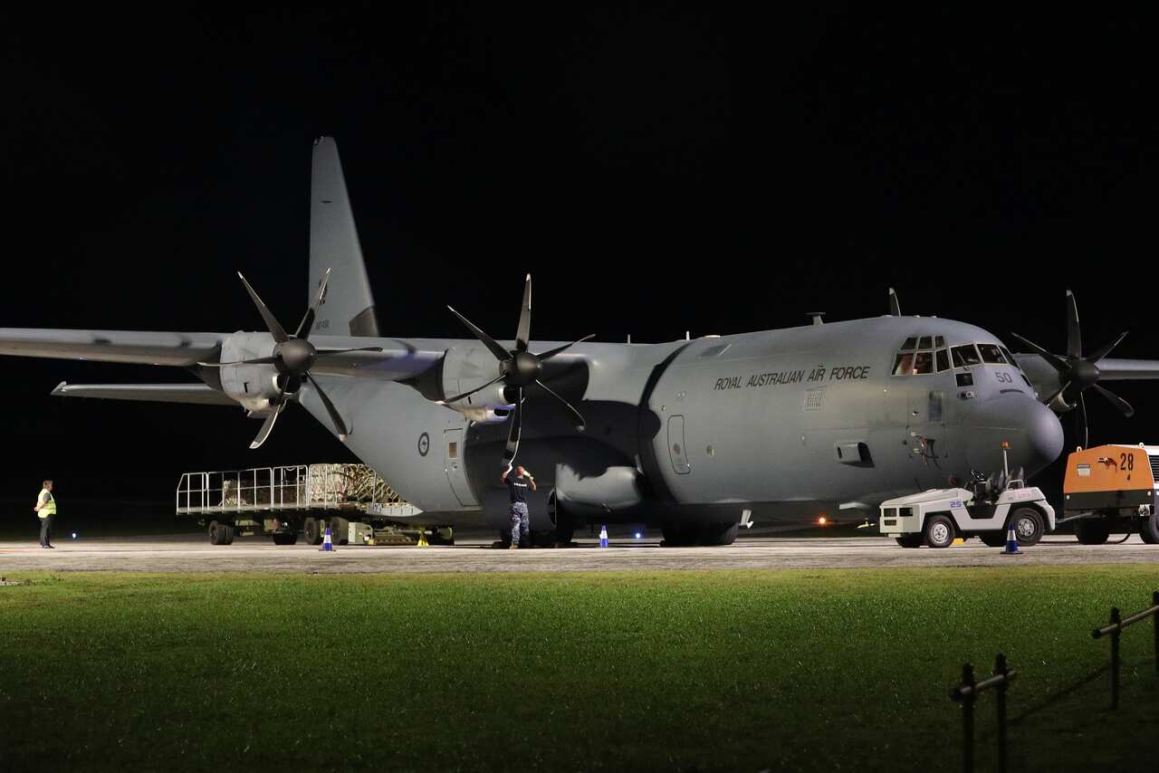 A RAAF Hercules is unloaded of supplies after arriving at Christmas Island. 