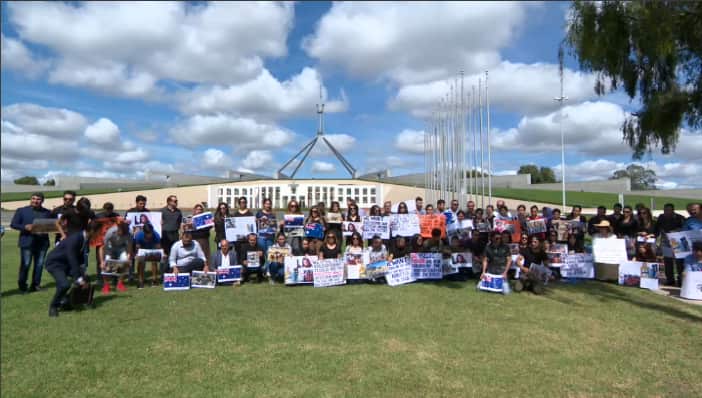 Yazidi supporters rally outside Parliament House, Canberra, Australia.