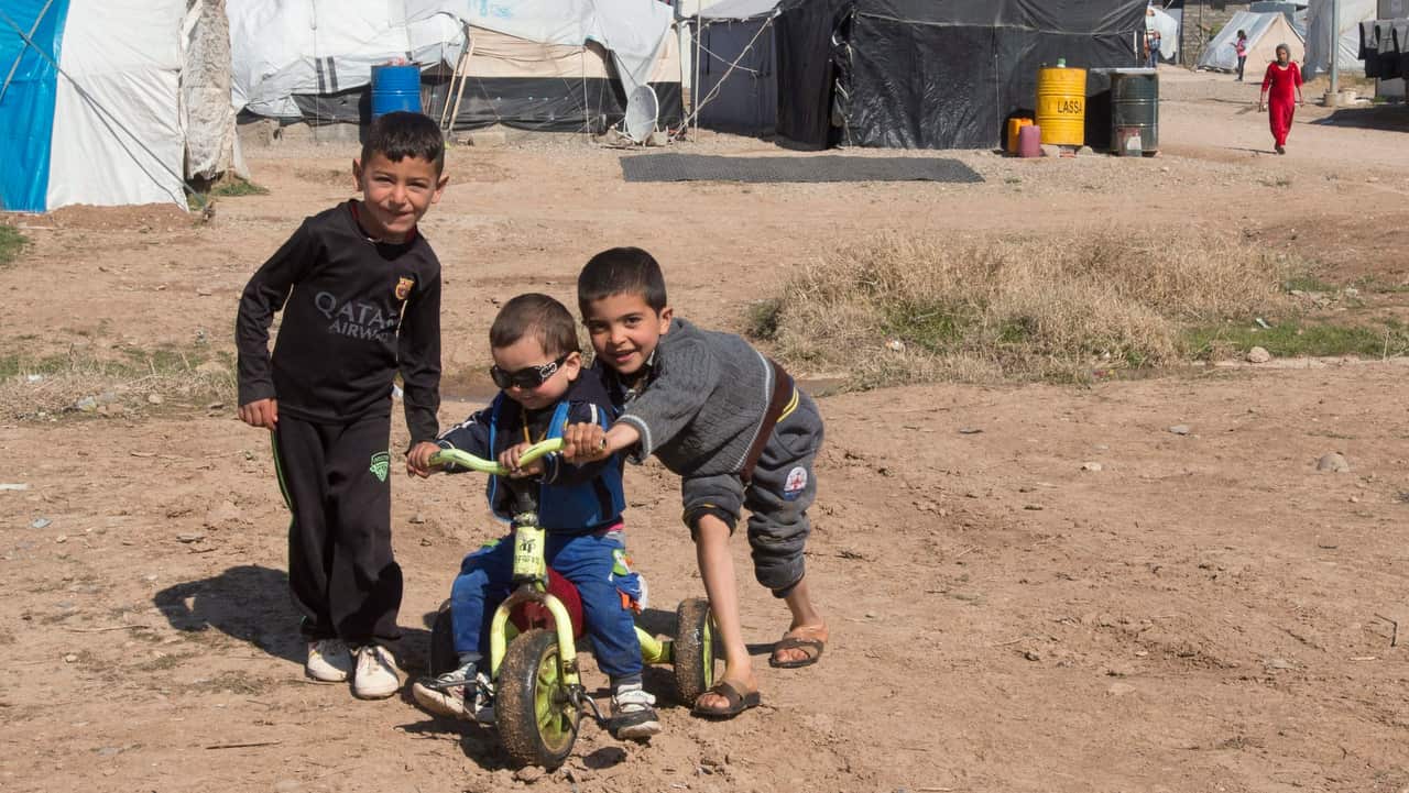 A group of Yazidi boys play at a camp for internal displaced persons, in Dohuk, Iraq.  