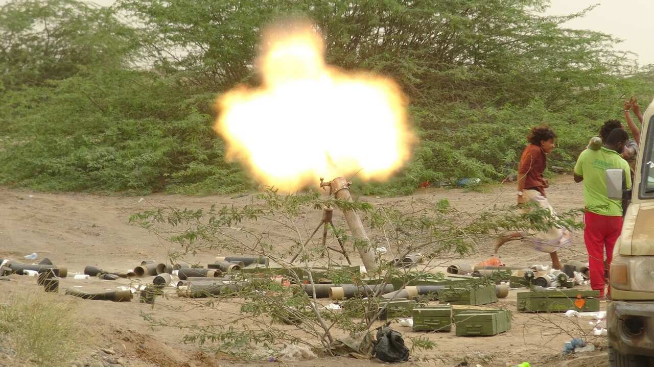 Yemeni pro-government forces fire a mortar near Hodeida.