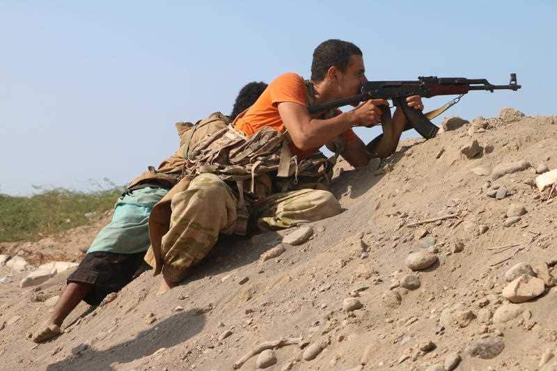 Yemeni pro-government forces take a position during clashes in the port city of Hodeidah, Yemen.
