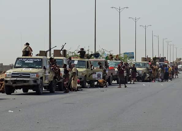 Yemeni pro-government forces gather on a highway on the eastern outskirts of Hodeida.