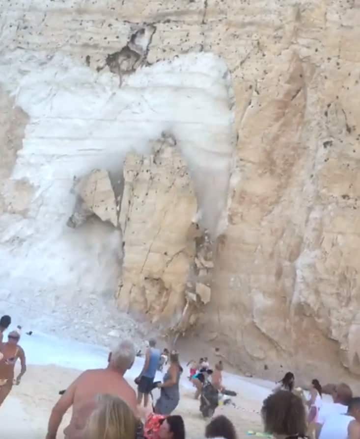 Two huge sheets of rock fell from the cliff face and crashed into the sea, capsizing boat