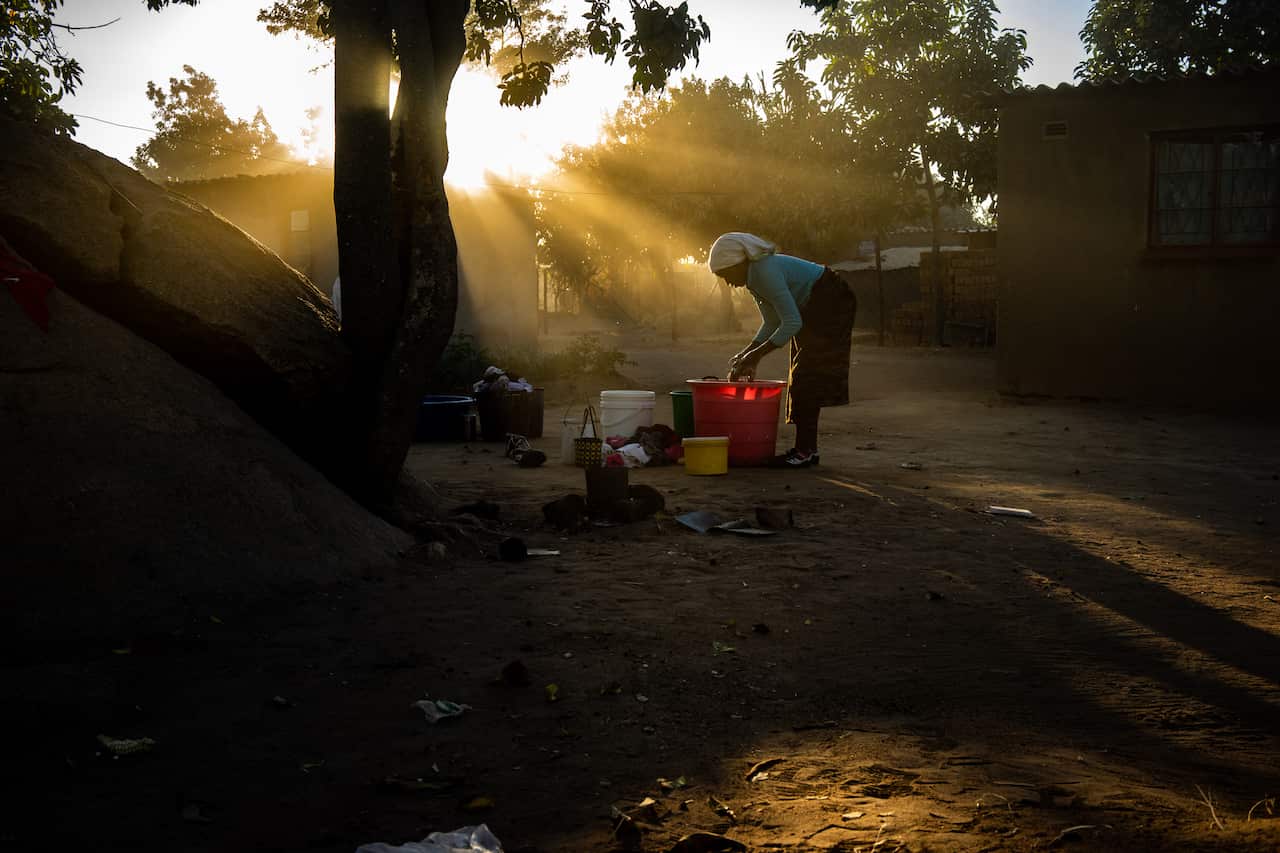 Angela Nyamurisa washes clothes in a bucket in Epworth, in southeast Harare, Zimbabwe. (Zinyange Auntony/The New York Times)