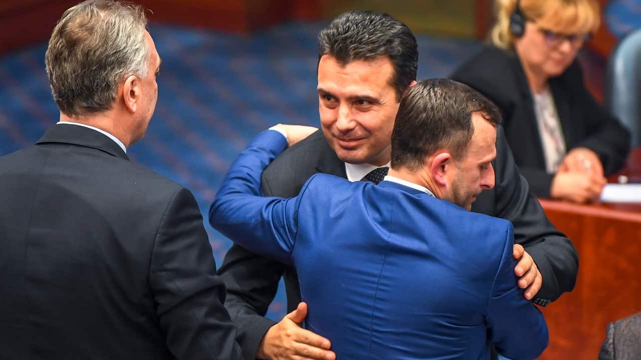Former Yugoslav Republic of Macedonia PM Zoran Zaev hugs a MP after the Parliament voted to change the country name to North Macedonia. 