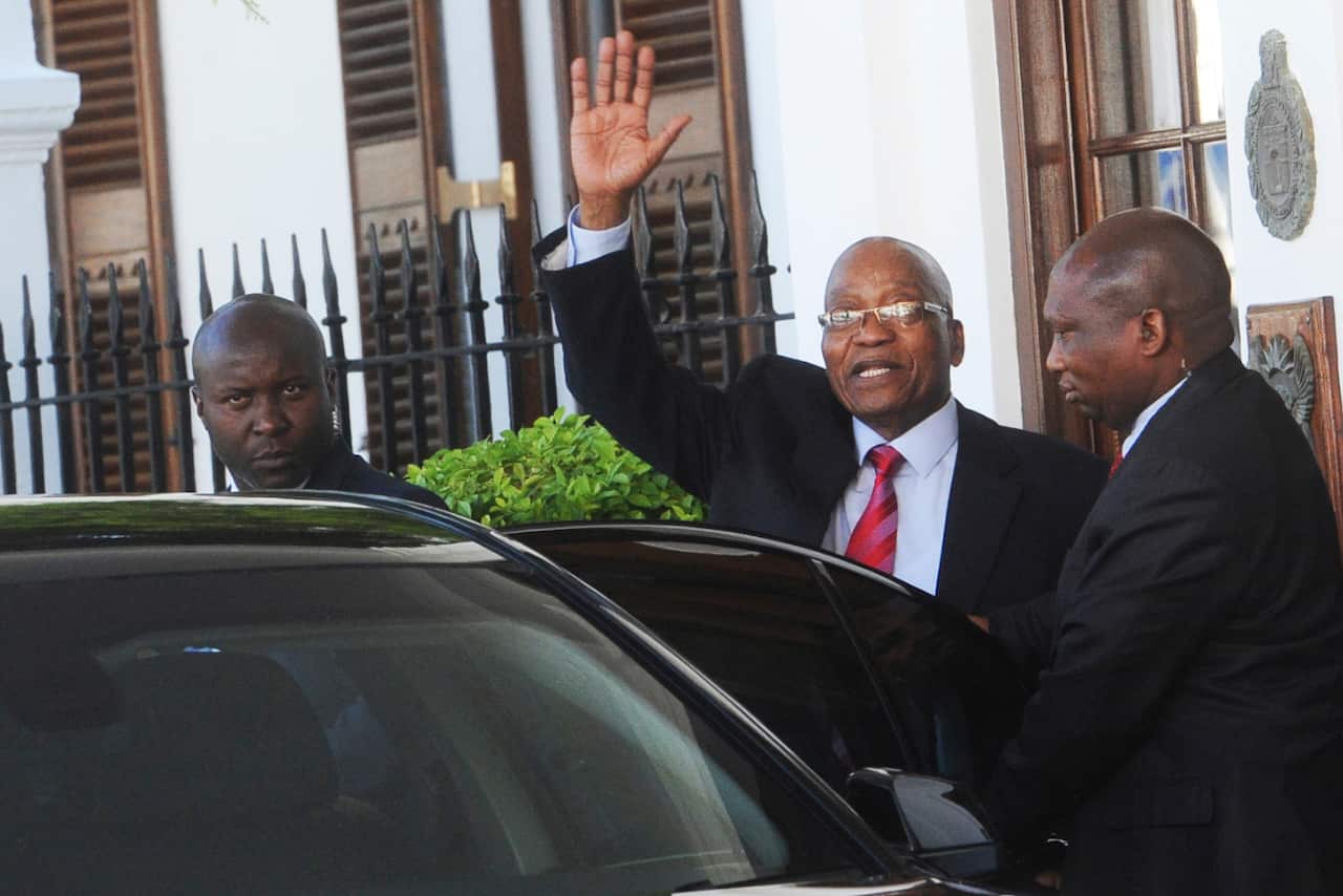 South African President Jacob Zuma, waves as he leaves parliament in Cape Town on Tuesday.