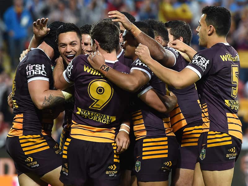 Brisbane Broncos players celebrate after scoring a try