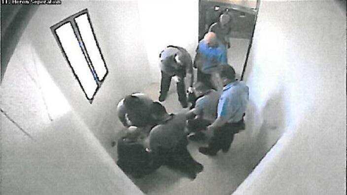 Guards surround a child in a Townsville detention centre in Queensland.