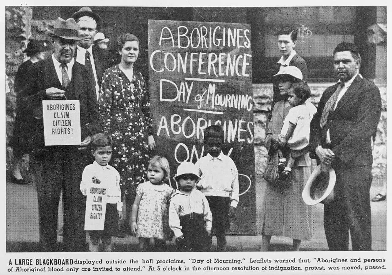 A group of men, women and children protest the first The first Day of Mourning in 1938.