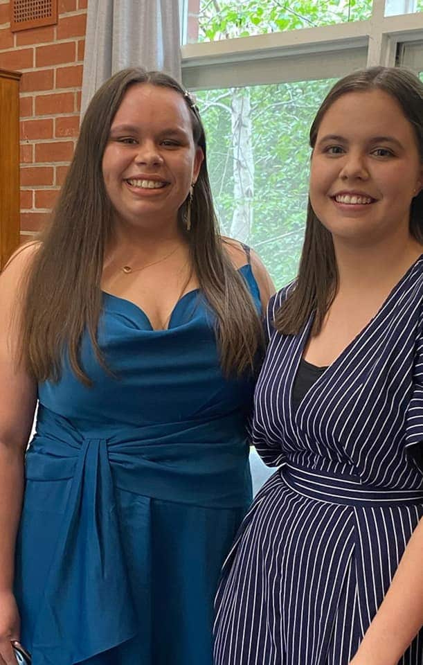 Two young women smiling