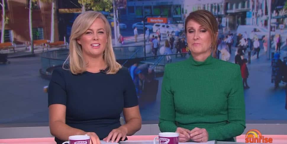 Sunrise presenters Sam Armytage and Natalie Barr put on a face as the show runs old overlay behind them to conceal a protest taking place earlier this morning.