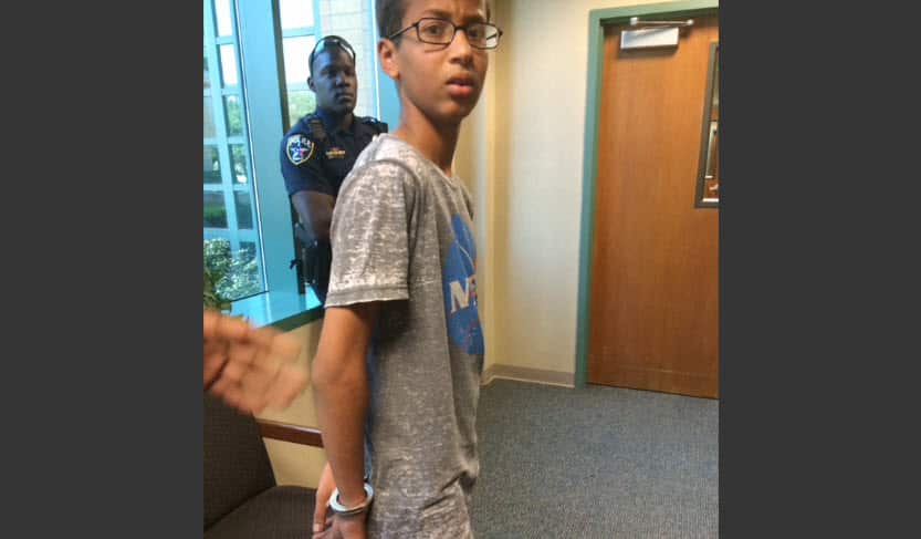 photo provided by Eyman Mohamed, her brother Ahmed Mohamed stands in handcuffs at Irving police department in Irving, Texas. 