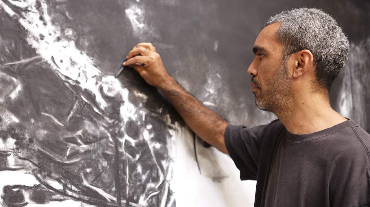 Daniel Boyd working on his art.