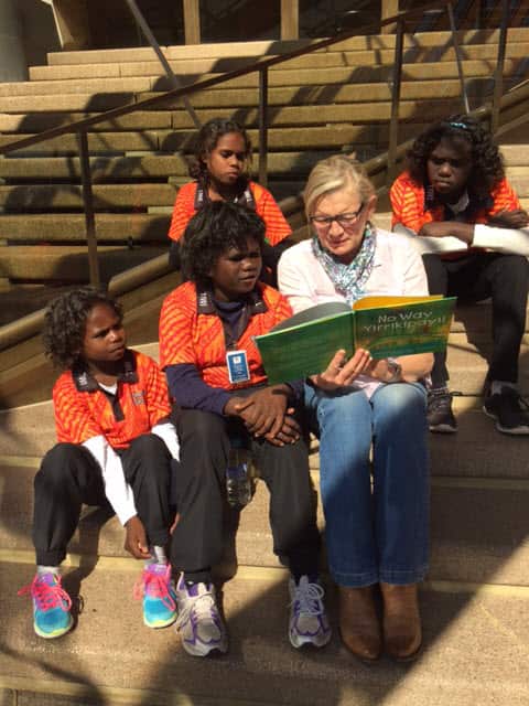 Four schoolchildren from Milikapiti School, Tiwi Islands read a book they wrote No Way Yirrikipayi! at the Opera House for Indigenous Literacy Day (Indigenous Literacy Foundation)