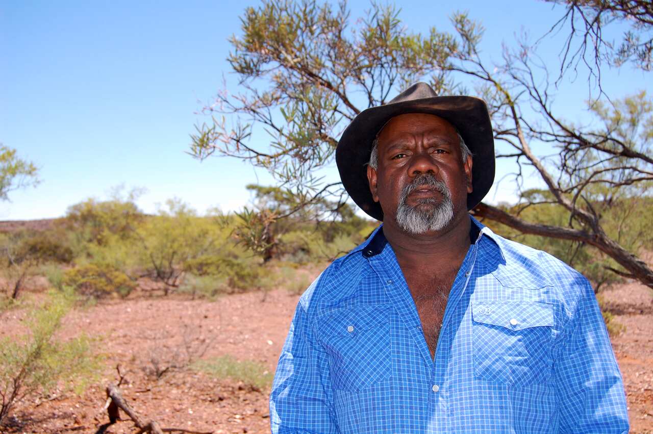 Peter Windie standing in the outback. 